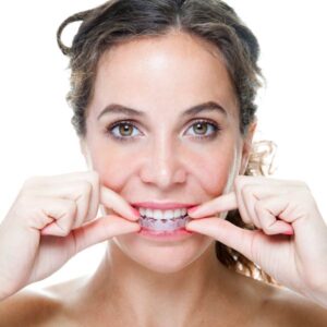 woman putting invisalign in mouth